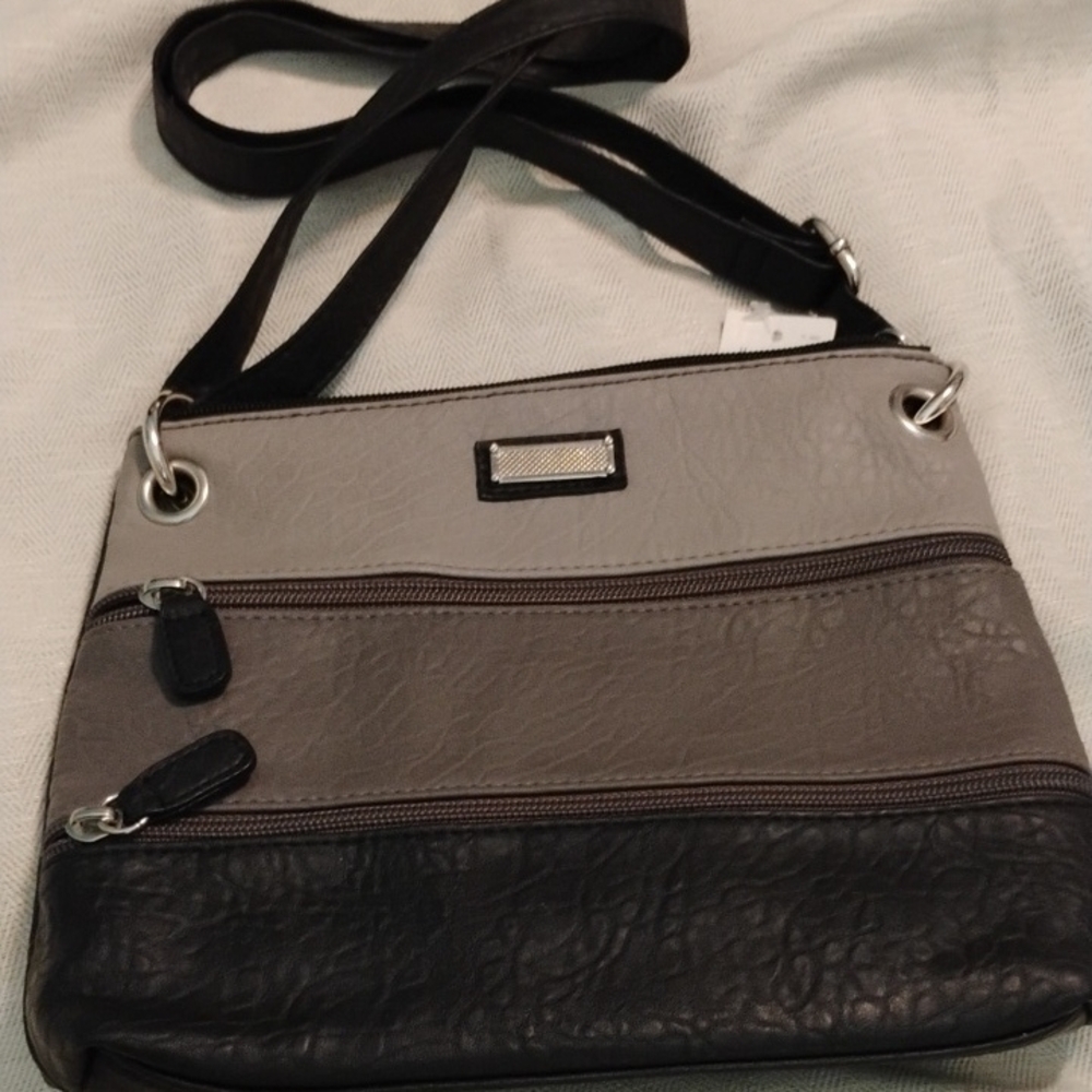 Grey and black VanHeusen cross body or over the shoulder purse.